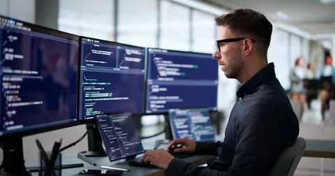 Young Software Engineer Coding New Algorithm On Laptop To Enhance Cybersecuri Stock Photos