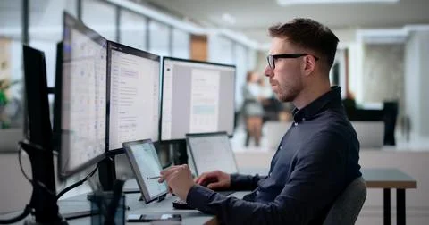 Young Software Engineer Works On Laptop Creating AI-powered Knowledge System. Фото