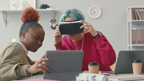 Young Software Engineers Looking at Tablet through VR Goggles Stock Footage 241263297