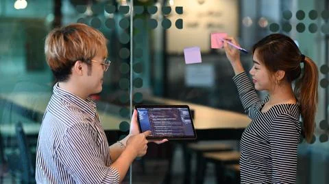 Young software engineers team discussing on project, working with programming Stockfoto's