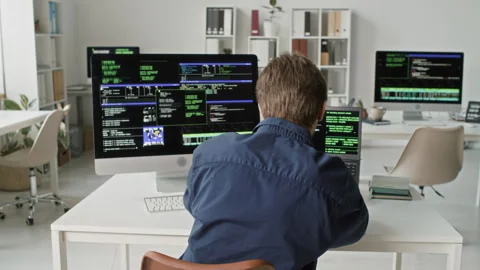 Young Software Male Developer Typing on Computer and Laptop at Office Desk Stock Footage 330124349