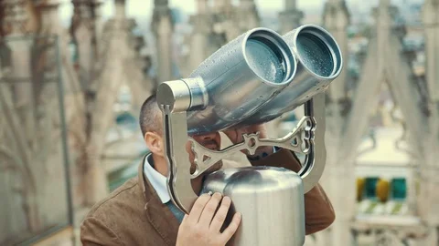 Young solid and charismatic man is observing something unusual in the sky throug Video stock 109179392