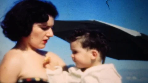 Young son gives mom a bite of his cookie 1950s vintage film home movie 4333 Stock Footage 82146078
