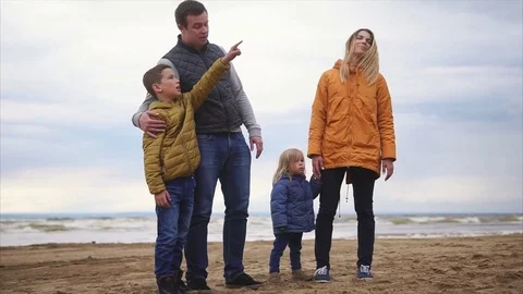 A young son is pointing away at a certain object, a friendly family is eyeing Stock Footage 76849833