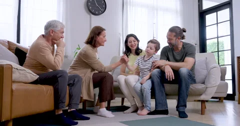 Young son sits between Asian mother and Caucasian father Stock Footage 340859902