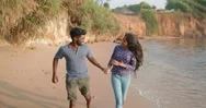 Young South Asian Couple Running Near The Indian Ocean Stock Footage