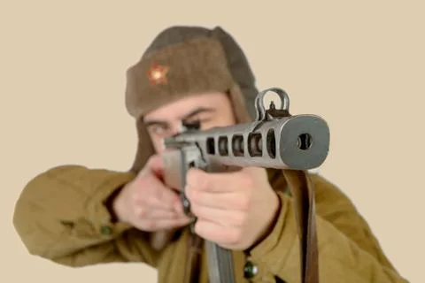 A young Soviet soldier fires with a machine gun Stock Photos
