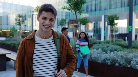 Young spanish student man looking at camera standing at college campus. Stock Footage 280324775