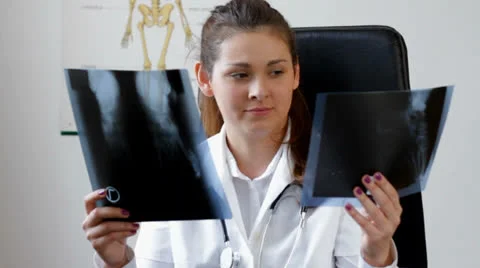 Young specialist compare two x-ray images Stock Footage 22903743
