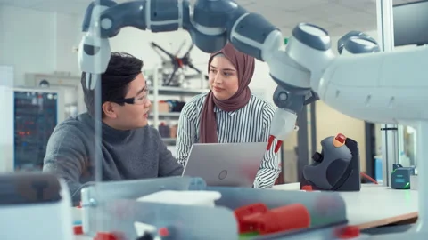 Young Specialist Talks With Asian Engineer Video stock 187574970