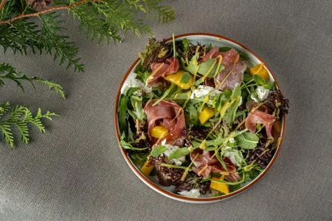 Young spinach in bacon and mango salad Stock Photos