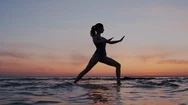 Young Sport And Flex Woman Exercising Yoga, Doing Warrior Pose On Beach During Stock Footage