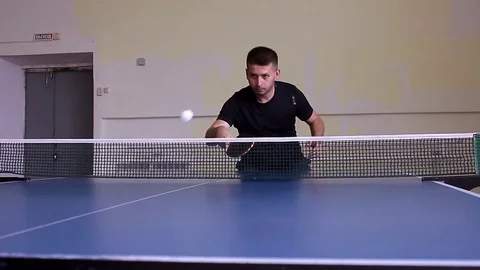 Young sports man table tennis player in play on old gym. Action shot. Stock Footage