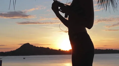 Young sports woman on the beach at sunrise background Stock Footage