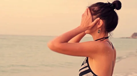 Young sports woman on the beach at sunrise background Stock Footage