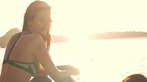 Young sports woman sit on the beach Stock Footage