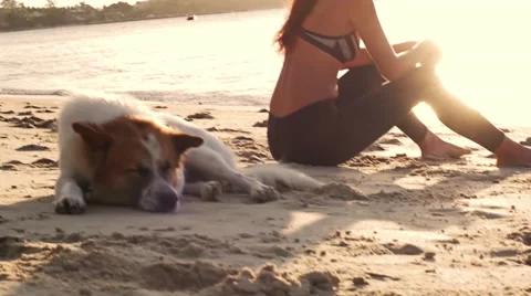 Young sports woman sit on the beach Stock Footage