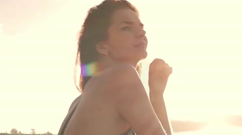Young sports woman sit on the beach Stock Footage