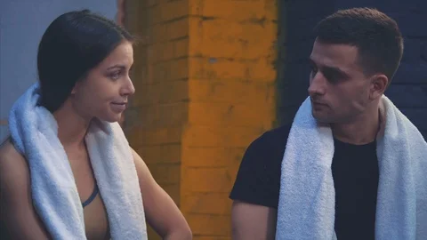 Young sporty couple guy and girl are in the gym. After a training session they Stock Footage 115848053