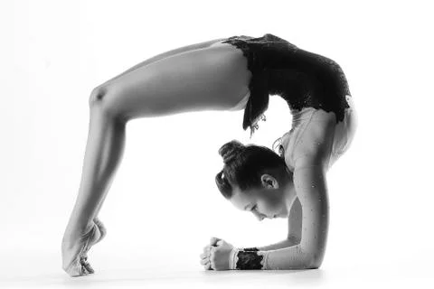 Young sporty woman doing acrobatic exercise Stock Photos