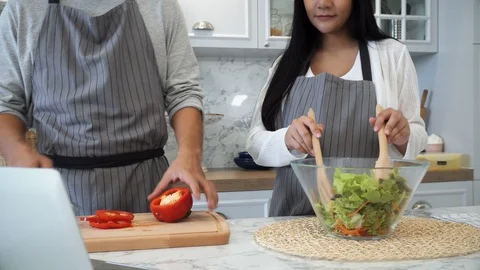 The young spouses cooking in kitchen together Stock Footage 87490837