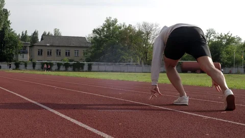 Young sprinter accelerates speed while running on race track Stock Footage 130168190