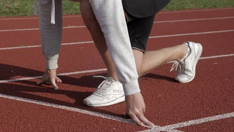 Young sprinter at the starting line on a race track moving Stock Footage 130168131