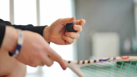 Young Squash Player Warms Ball in Hand – Slow Motion Close Up Indoors Latvia Stock Footage 311054450