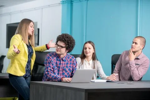 Young start up team disccusing projects Stock Photos