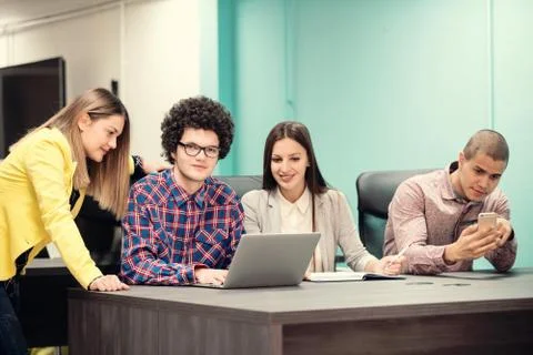 Young start up team disccusing projects Stock Photos