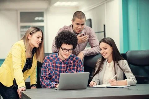 Young start up team disccusing projects Stock Photos