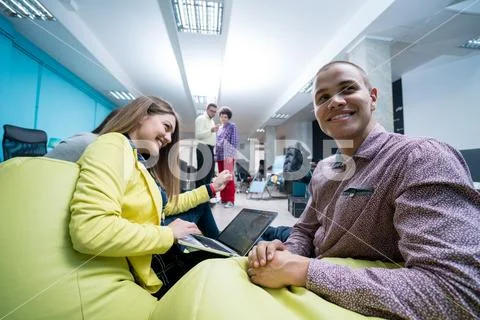 Young start up team disccusing projects Stock Photos