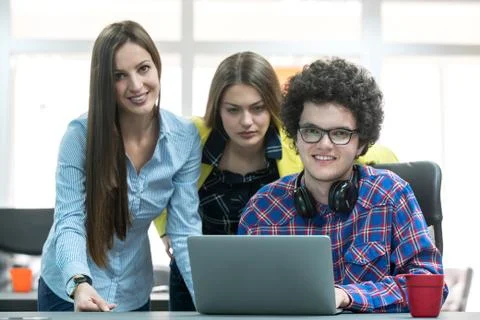 Young start up team disccusing projects Stock Photos