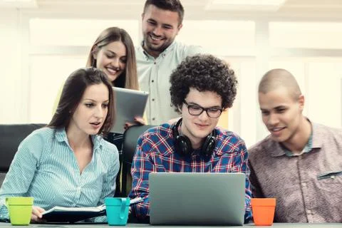 Young start up team disccusing projects Stock Photos