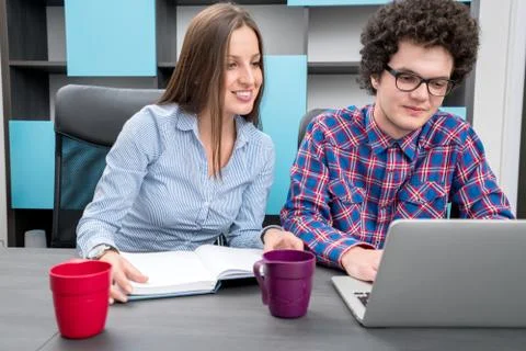 Young start up team disccusing projects Stock Photos