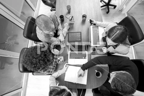 Young start up team disccusing projects Stock Photos