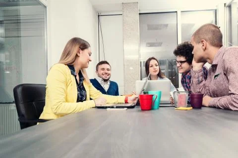 Young start up team disccusing projects Stock Photos