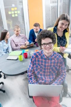 Young start up team disccusing projects Stock Photos