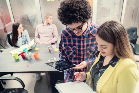 Young start up team disccusing projects Stock Photos