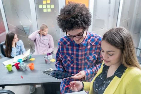 Young start up team disccusing projects Stock Photos
