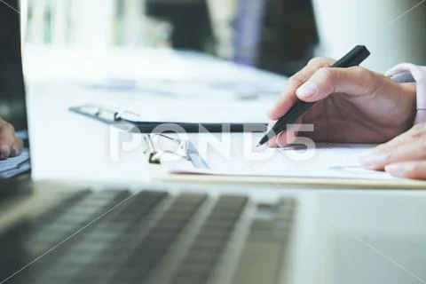 Young startup businessman hands typing on laptop keyboard. Stock Photos