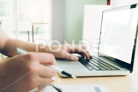 Young startup businessman hands typing on laptop keyboard Stock Photos
