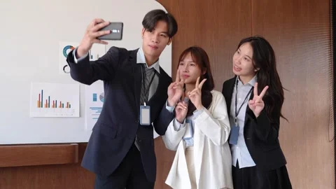 Young startup colleagues taking a fun selfie together during a break in the.. Stock Footage 304190055