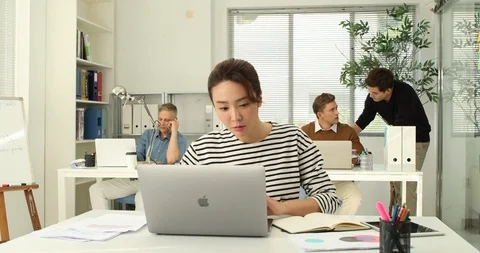 Young startup members working in the office Stock Footage 100958479