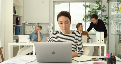 Young startup members working in the office Stock Footage 100958574