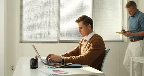 Young startup members working in the office Stock Footage 100959225