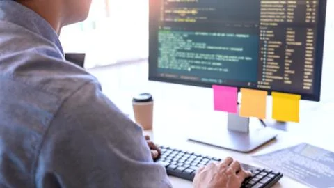 Young startup Programmers Sitting At Desks Working On Computers screen for De 스톡 사진