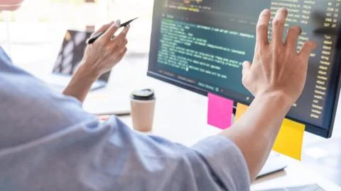 Young startup Programmers Sitting At Desks Working On Computers screen for De 스톡 사진