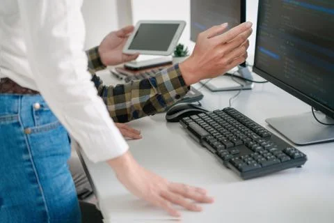 Young startup Programmers Sitting At Desks Working On Computers screen for De 库存照片