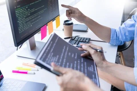 Young startup Programmers Sitting At Desks Working On Computers screen for De 库存照片